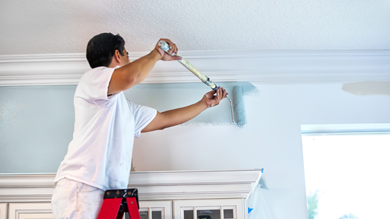 Interior & exterior remodel with contractor painting walls for a fresh home upgrade.